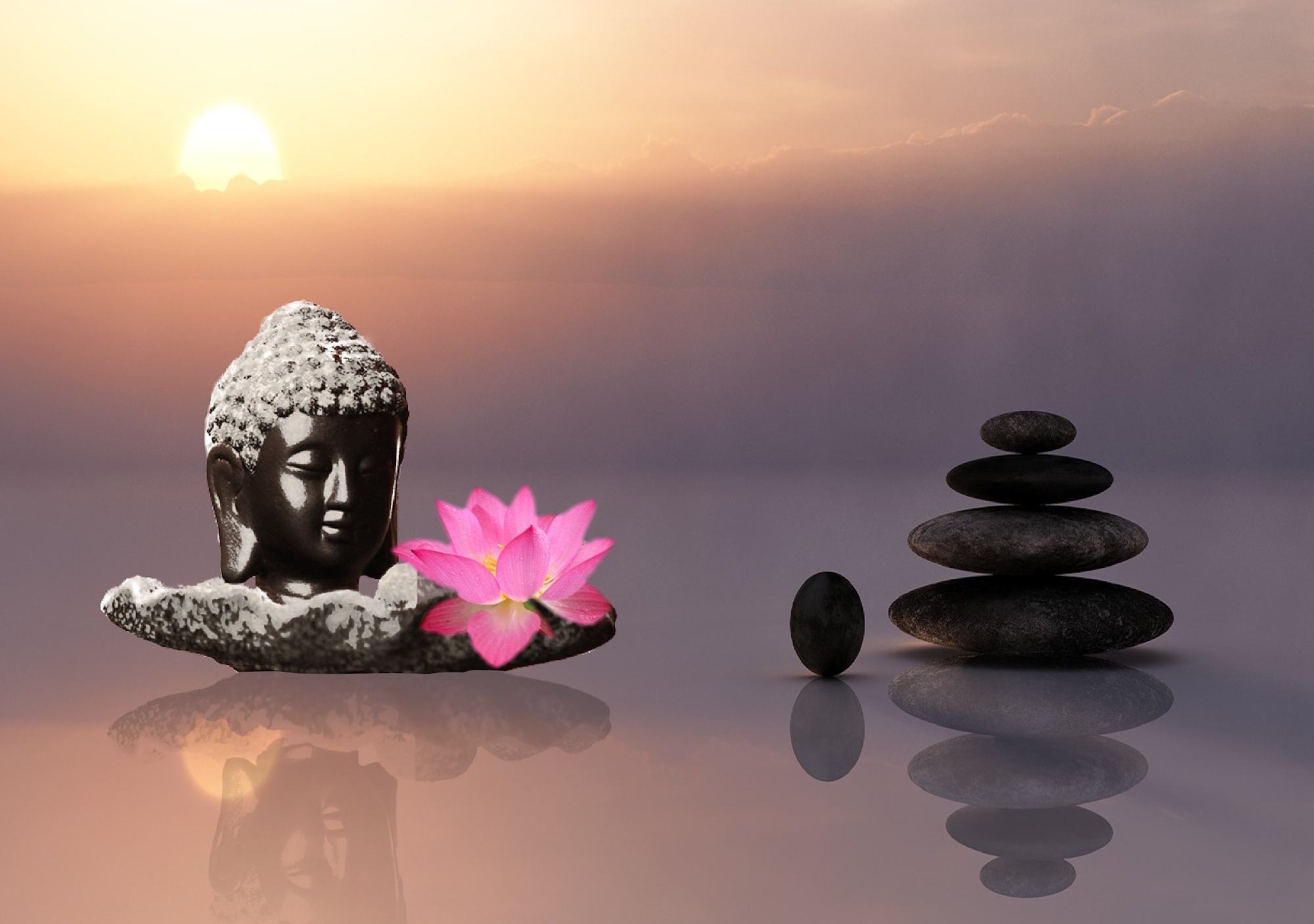 Image of Bhudda statue flower and stone pile showing serenity
