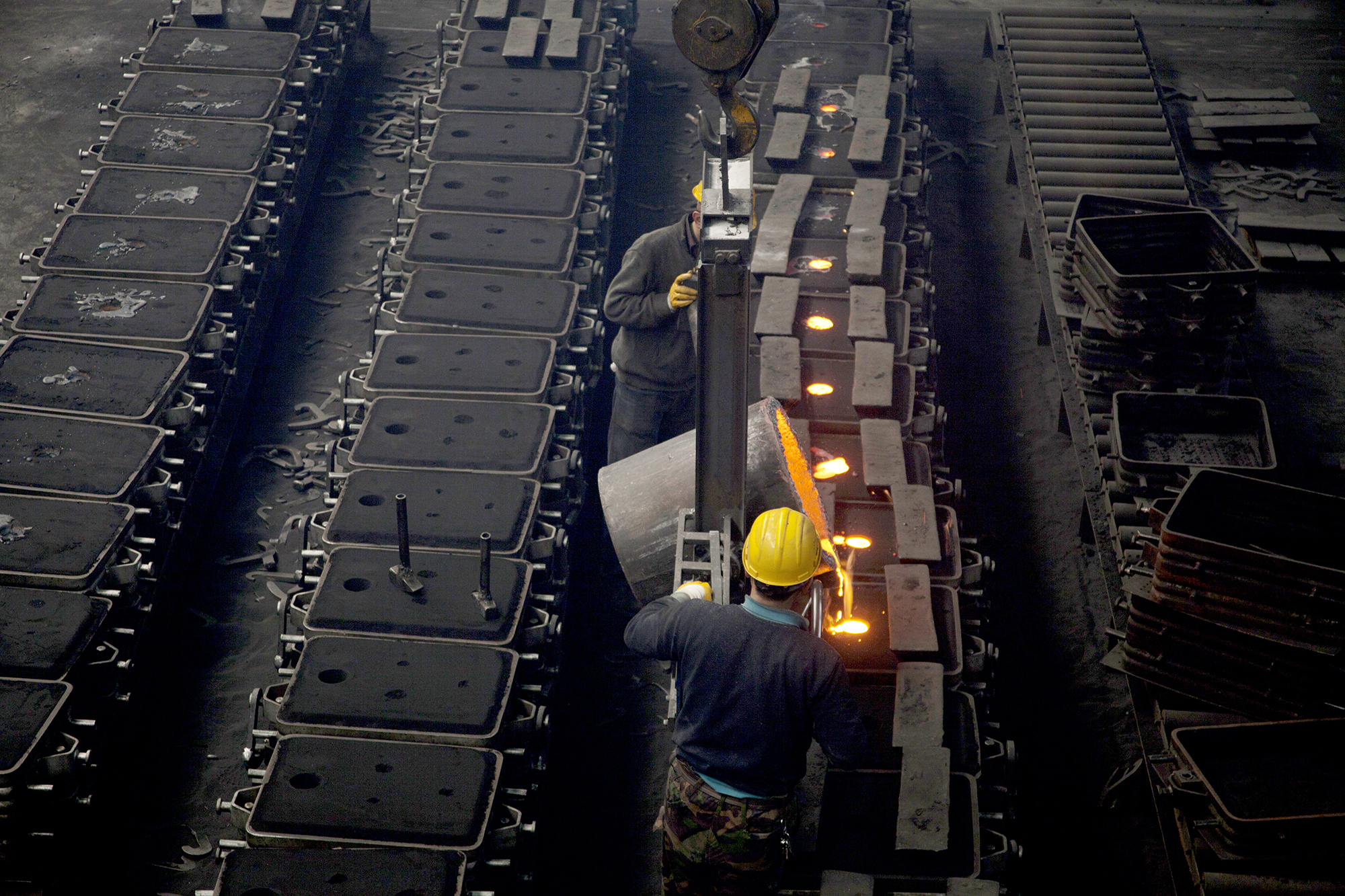 image of workers in a foundry at the melting furnace