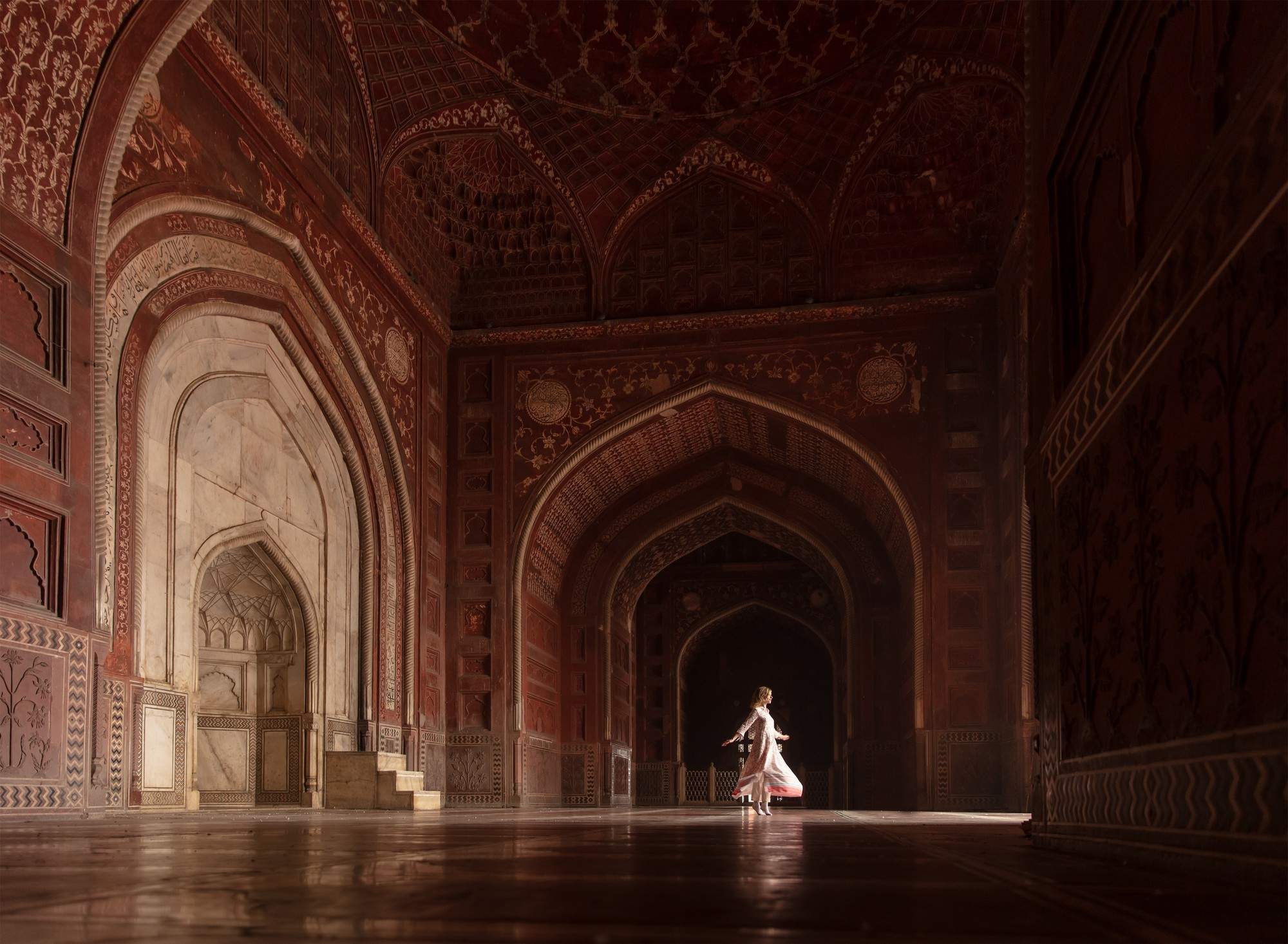 image of a dancing woman in the distance in a huge ballroom of an Indian palace