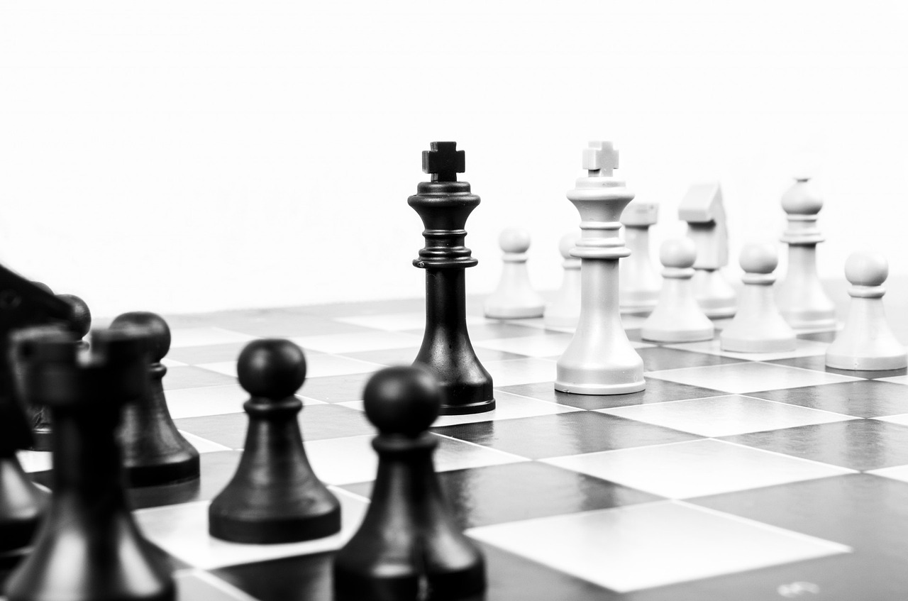 Image of chess game with board and black and white pieces
