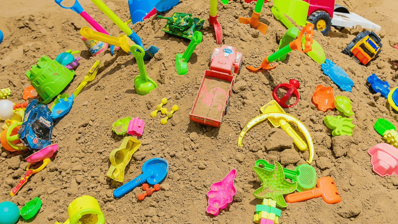 Image of a children's playground with toys on a sand mount